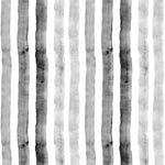 Detail of wallpaper in a painterly stripe print in shades of gray on a white field.