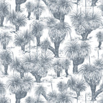 Detail of fabric in a painterly tree print in navy on a white field.