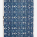 Roll of printed grasscloth with ikat stripe design in blue and cream 
