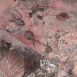 Draped fabric in an underwater sealife scene in shades of warm blush and grey. 