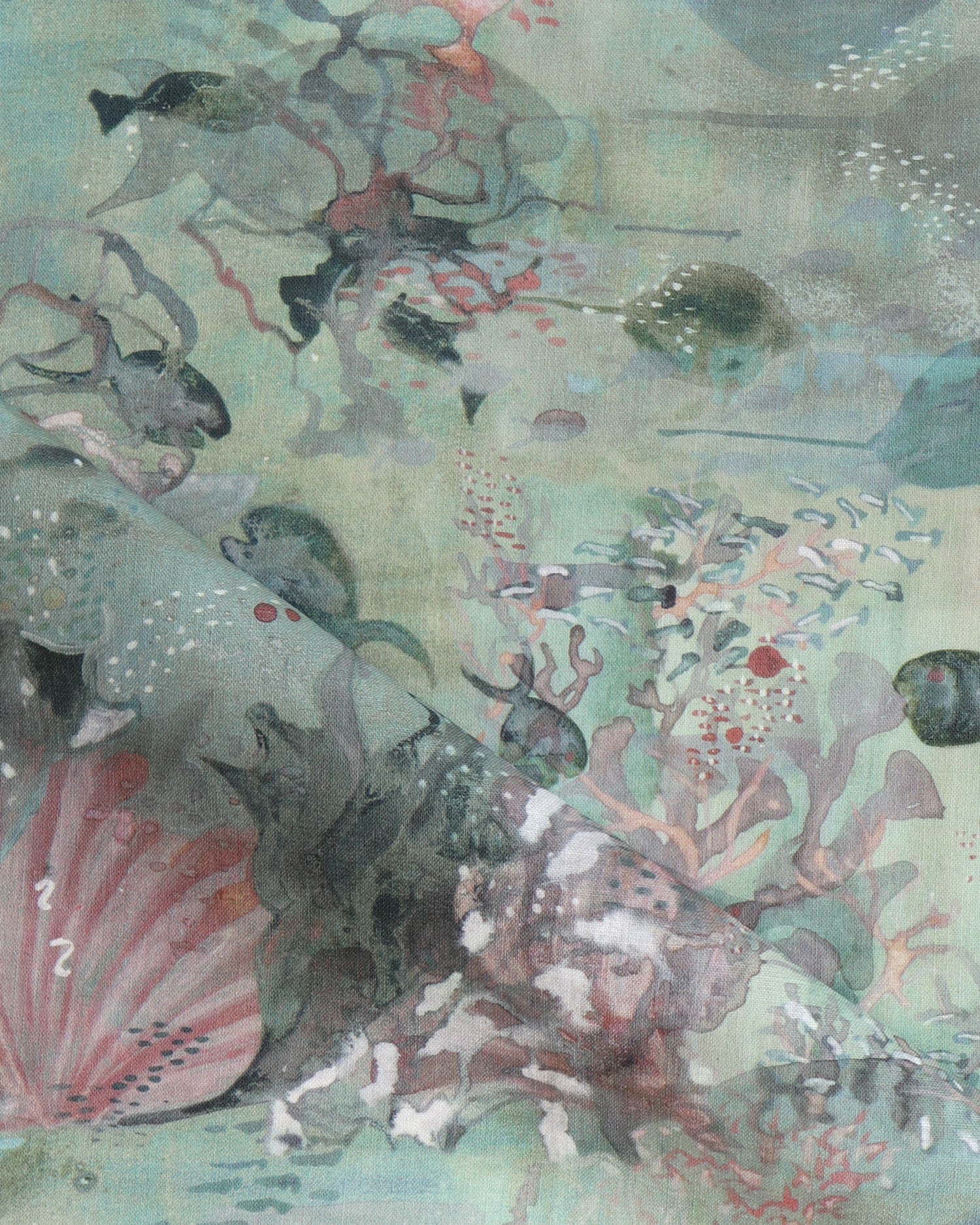 Draped fabric in an underwater sealife scene in shades of sage green with coral accents. 