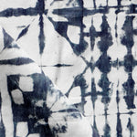 Detail of draped fabric in a watercolor dyed grid print in mottled white and navy.
