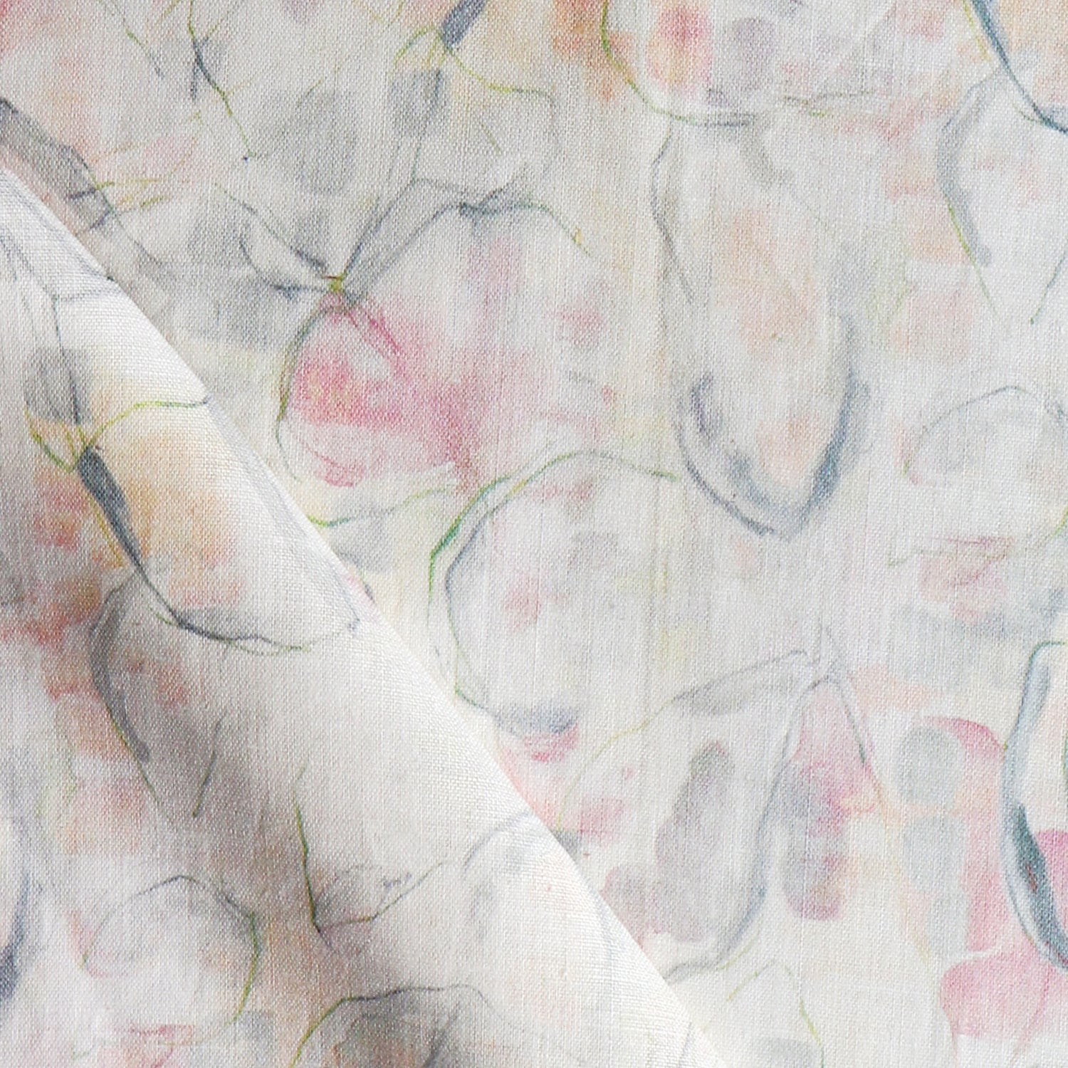 Detail of draped fabric in a watercolor painterly print in shades of pastel, green and cream.