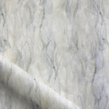 Draped fabric in a layered squiggle watercolor pattern in shades of grey and warn tan, 