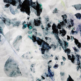 Detail of draped fabric in a watercolor paint blotch print in black, gray, blue and green on a white field.