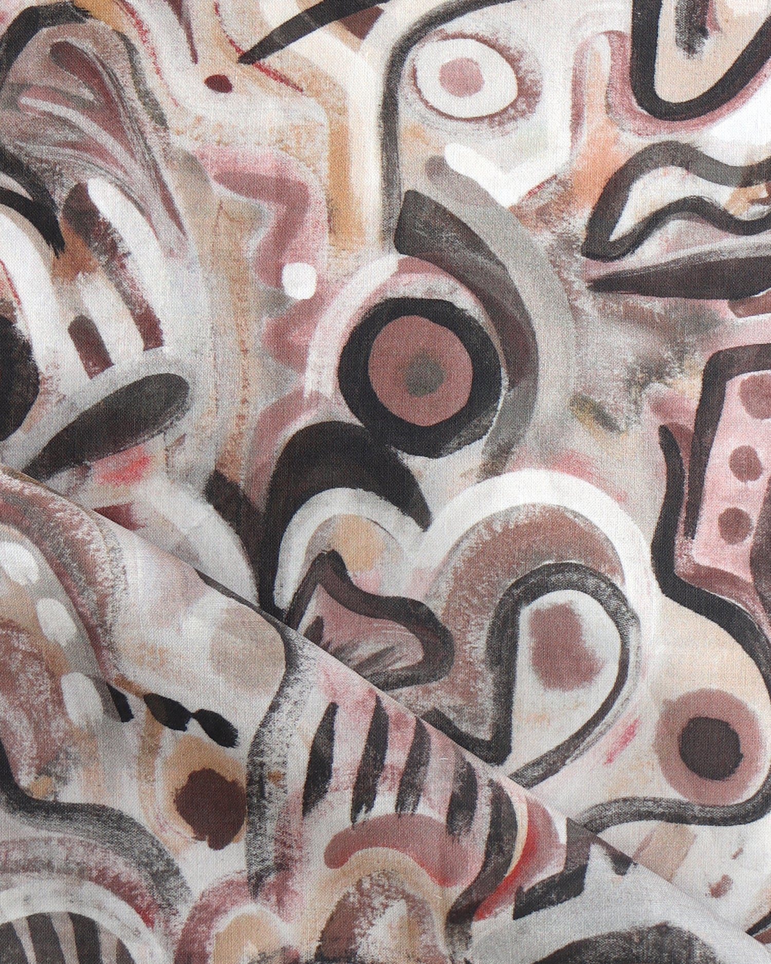 Draped fabric in abstract brushstroke design in shades of rust, tan and black accents. 