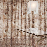 Floor length curtain in  abstract floral bushstroke design in soft brown with grey with a metal and glass table. 