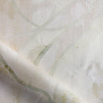 Draped fabric in abstract floral bushstroke design in warm beige. 