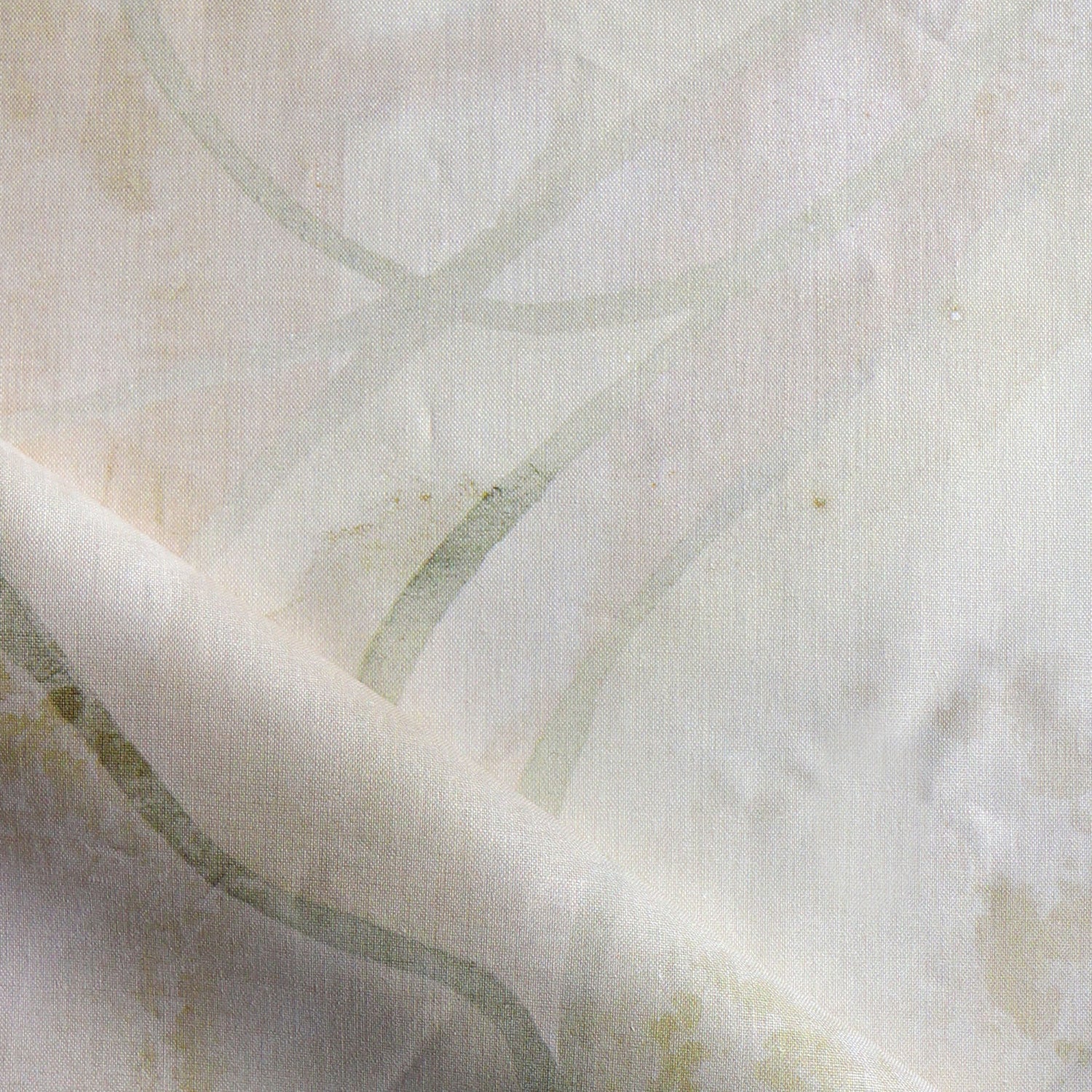 Draped fabric in abstract floral bushstroke design in warm beige. 