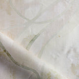 Draped fabric in abstract floral bushstroke design in warm beige. 