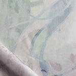 Draped fabric in abstract floral bushstroke design in sage green, lilac and blue. 