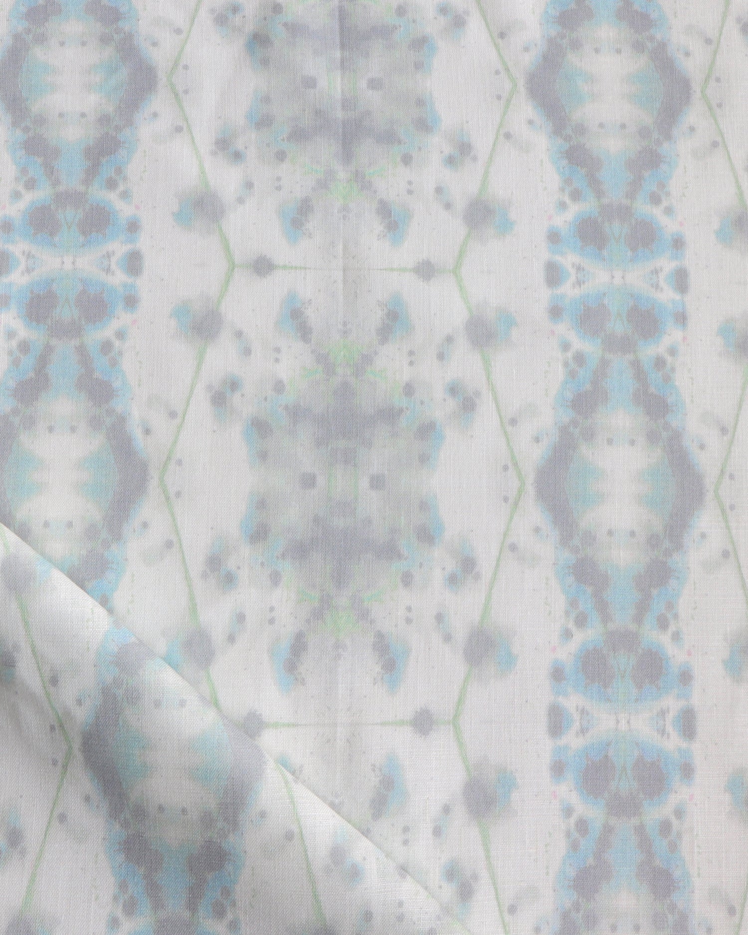 Detail of draped fabric in a painterly gometric stripe in gray, blue and green on a white field.