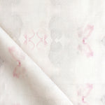 Detail of draped fabric in a striped ink blot print in shades of tan and pink on a cream field.