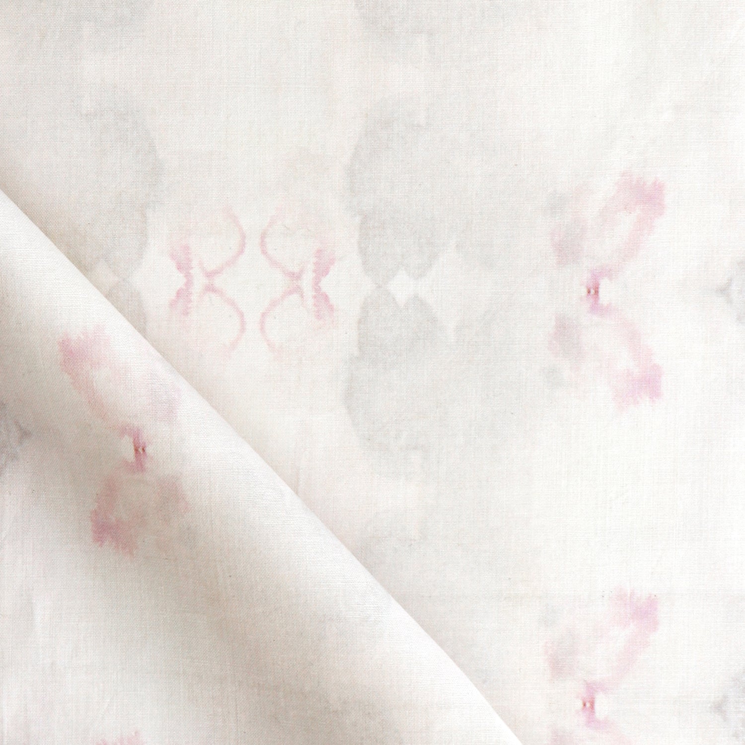 Detail of draped fabric in a striped ink blot print in shades of tan and pink on a cream field.