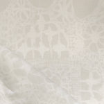Close-up of a watercolor lace design in soft beige. 