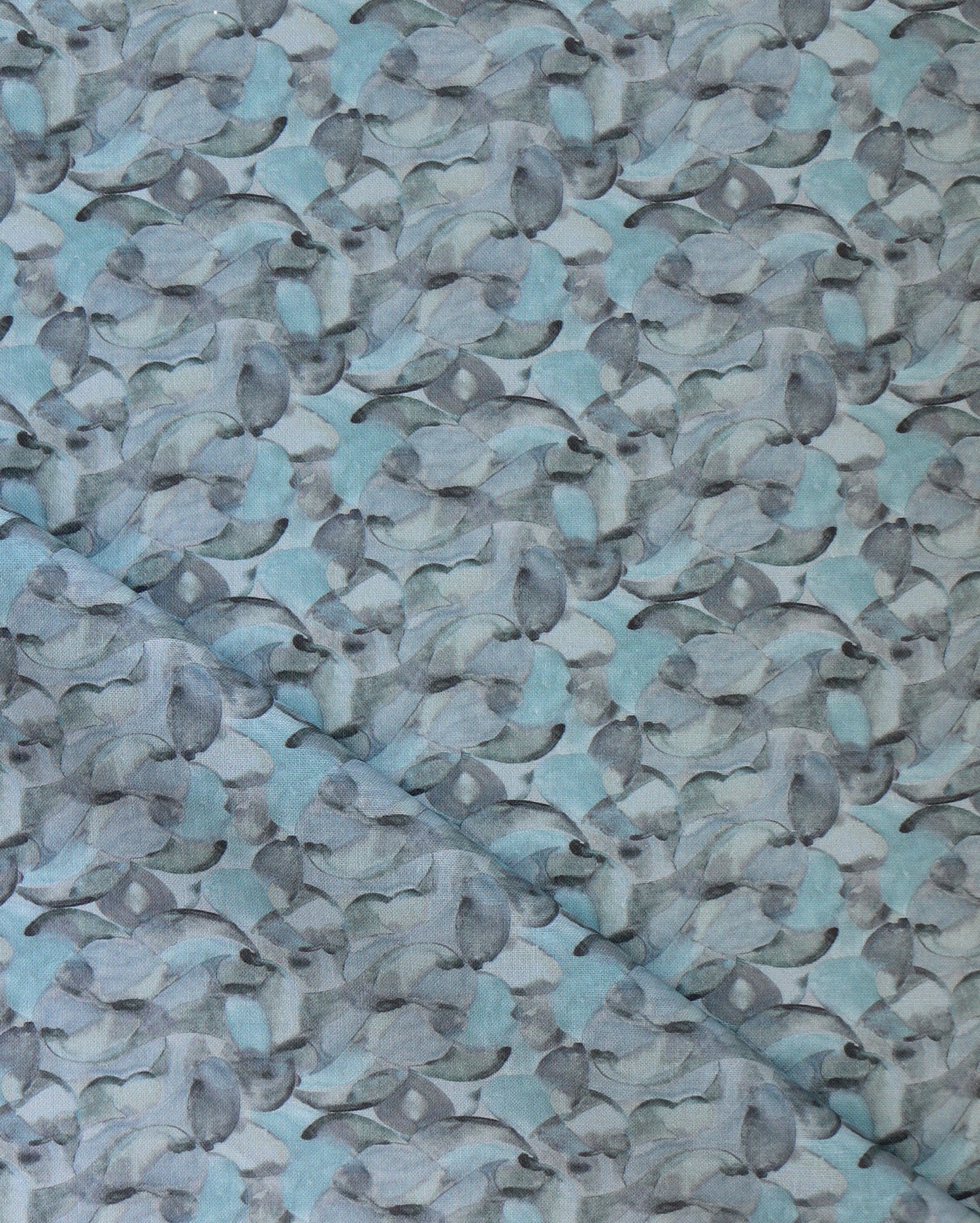 Draped fabric in an undulating abstract watercolor motif in shades of steel blue and charcoal. 