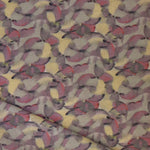 Draped fabric in an undulating abstract watercolor motif in purple, taupe, yellow and charcoal. 