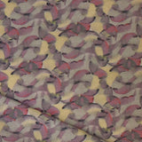 Draped fabric in an undulating abstract watercolor motif in purple, taupe, yellow and charcoal. 
