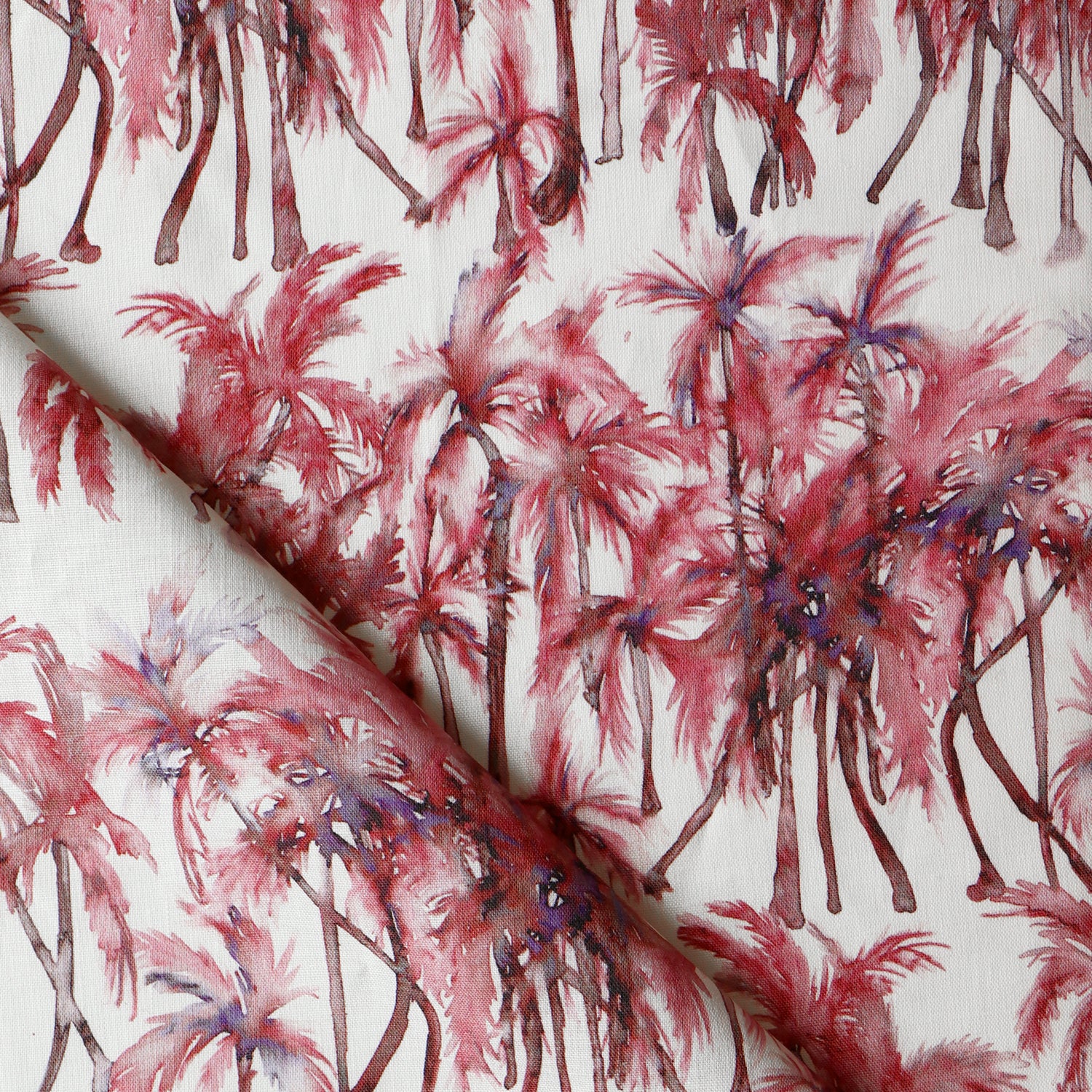Detail of draped fabric in a painterly palm tree stripe print in shades of pink and red on a white field.