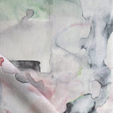 Detail of draped fabric in a watercolor painterly print in shades of pink, gray and white.