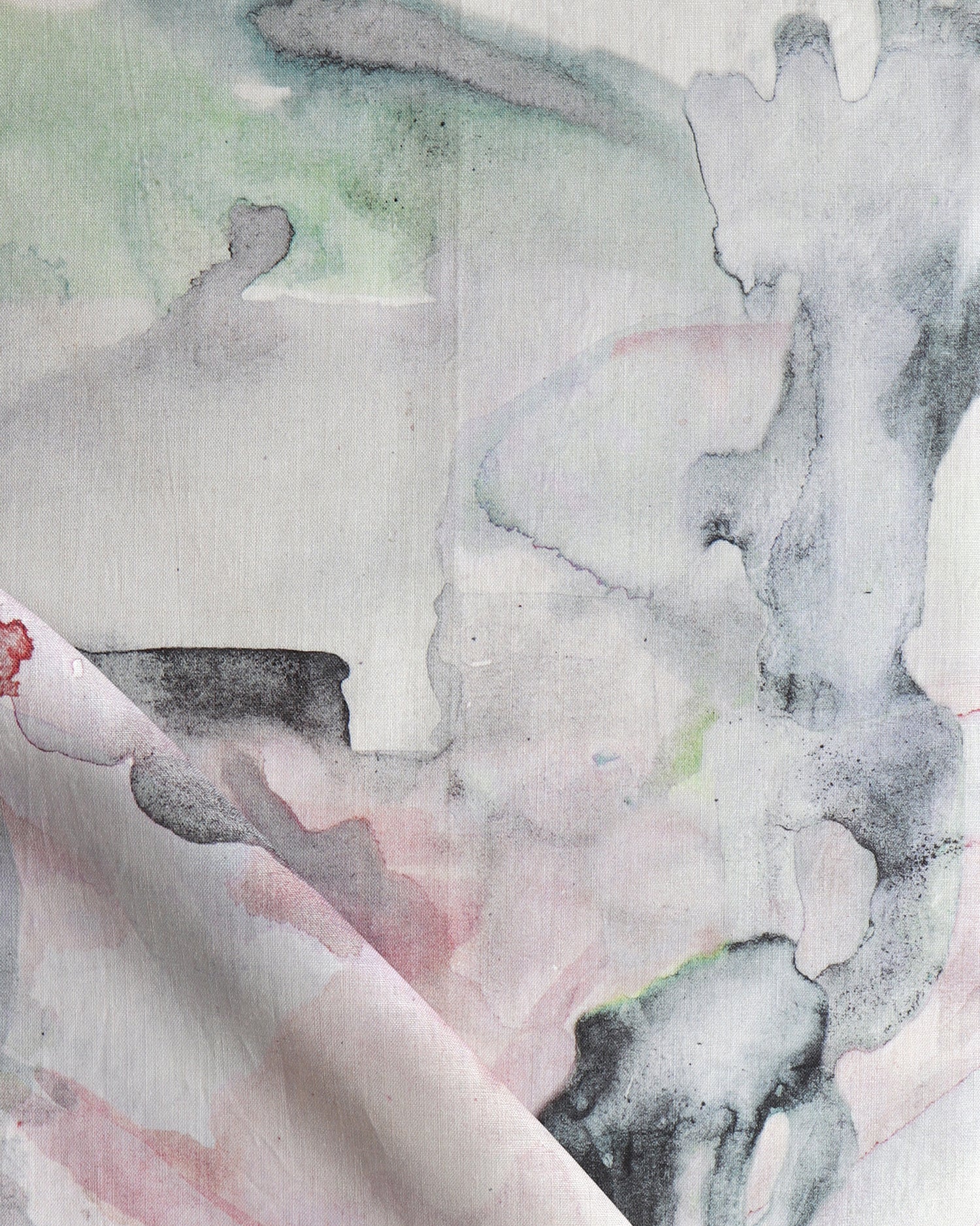 Detail of draped fabric in a watercolor painterly print in shades of pink, gray and white.