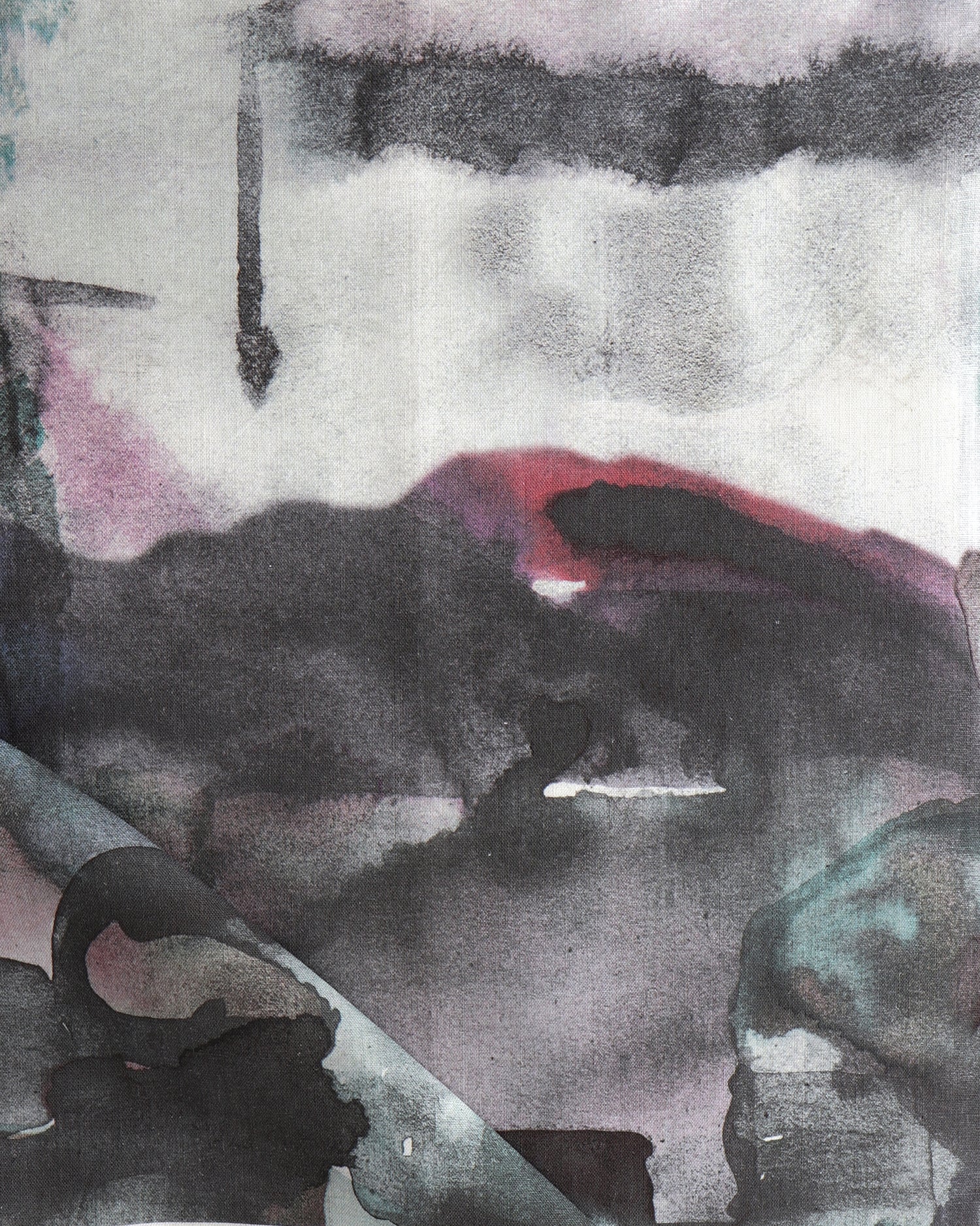 Detail of draped fabric in a watercolor painterly print in shades of pink, turquoise and gray.