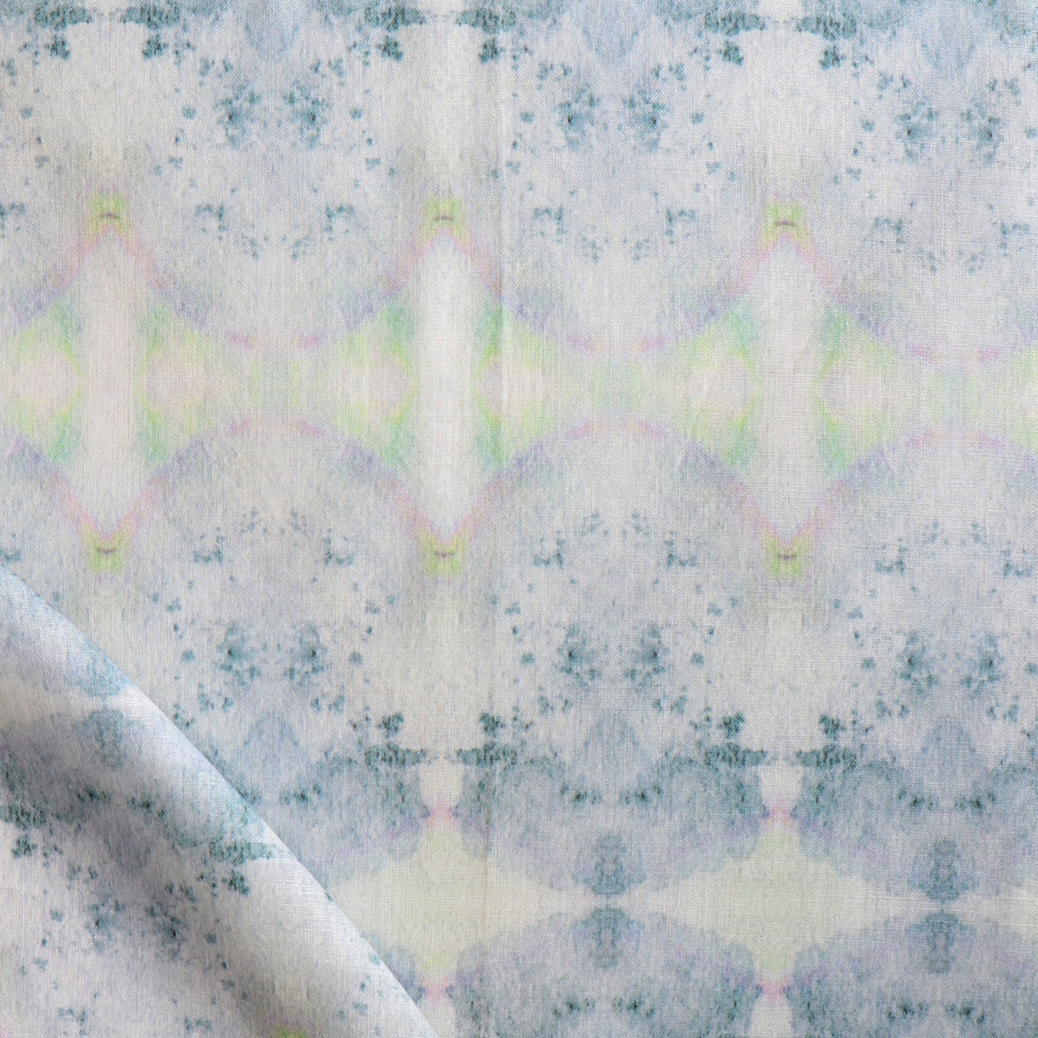 Detail of draped fabric in a watercolor ink blot pattern in shades of gray, green and pink.