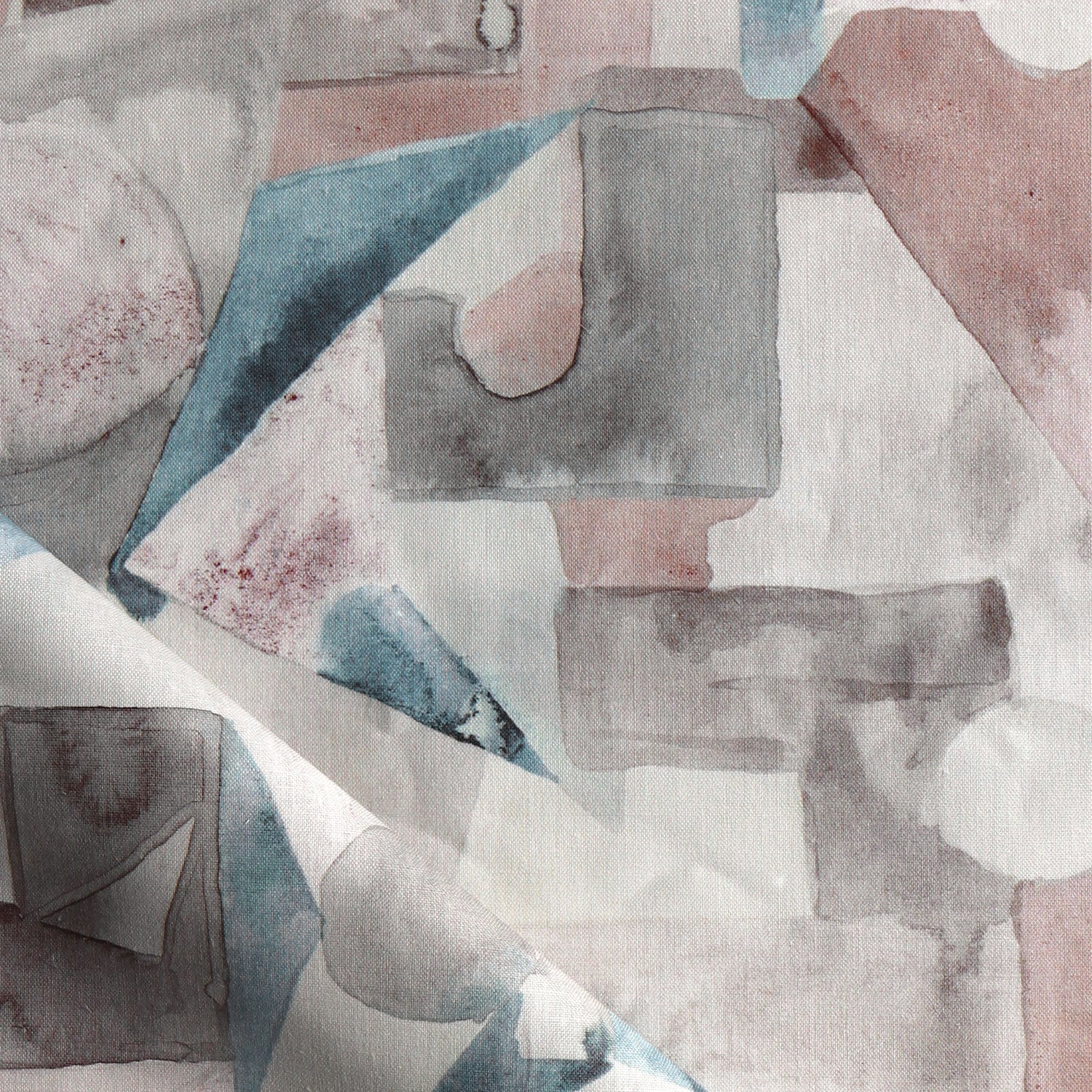 Draped fabric in a geometric puzzle piece watercolor pattern in blush, grey and teal. 