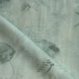 Draped fabric in an watercolor oceanic fish pattern in sage green. 