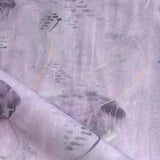 Draped fabric in an watercolor oceanic fish pattern light purple. 