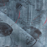 Draped fabric in an watercolor oceanic fish pattern in navy blue. 