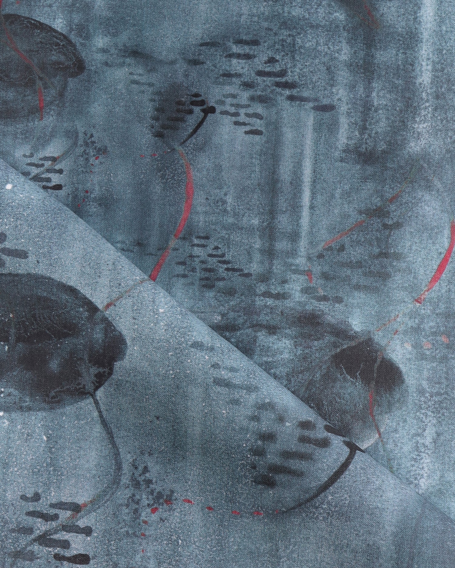 Draped fabric in an watercolor oceanic fish pattern in navy blue. 