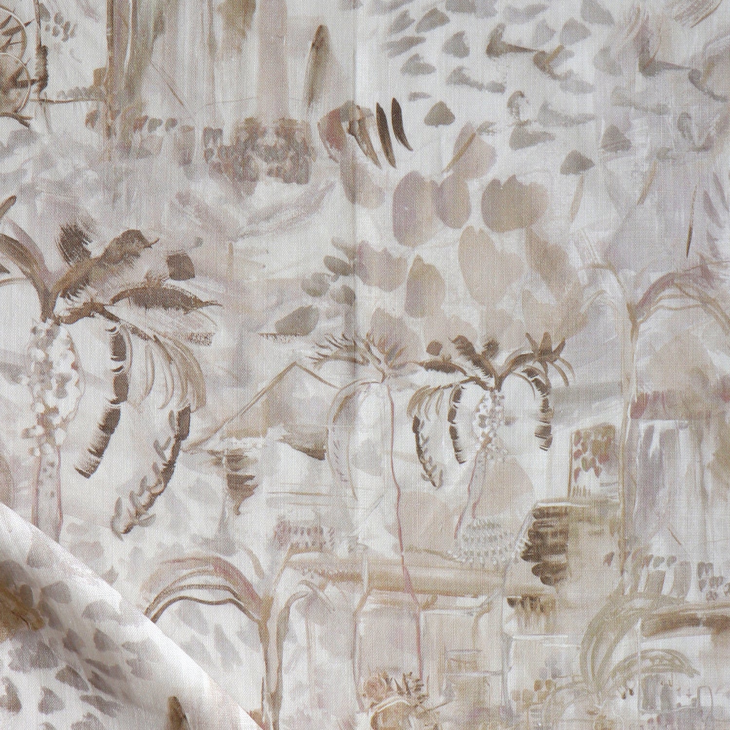 Detail of draped fabric in a painterly tree print in shades of gray, tan and cream.