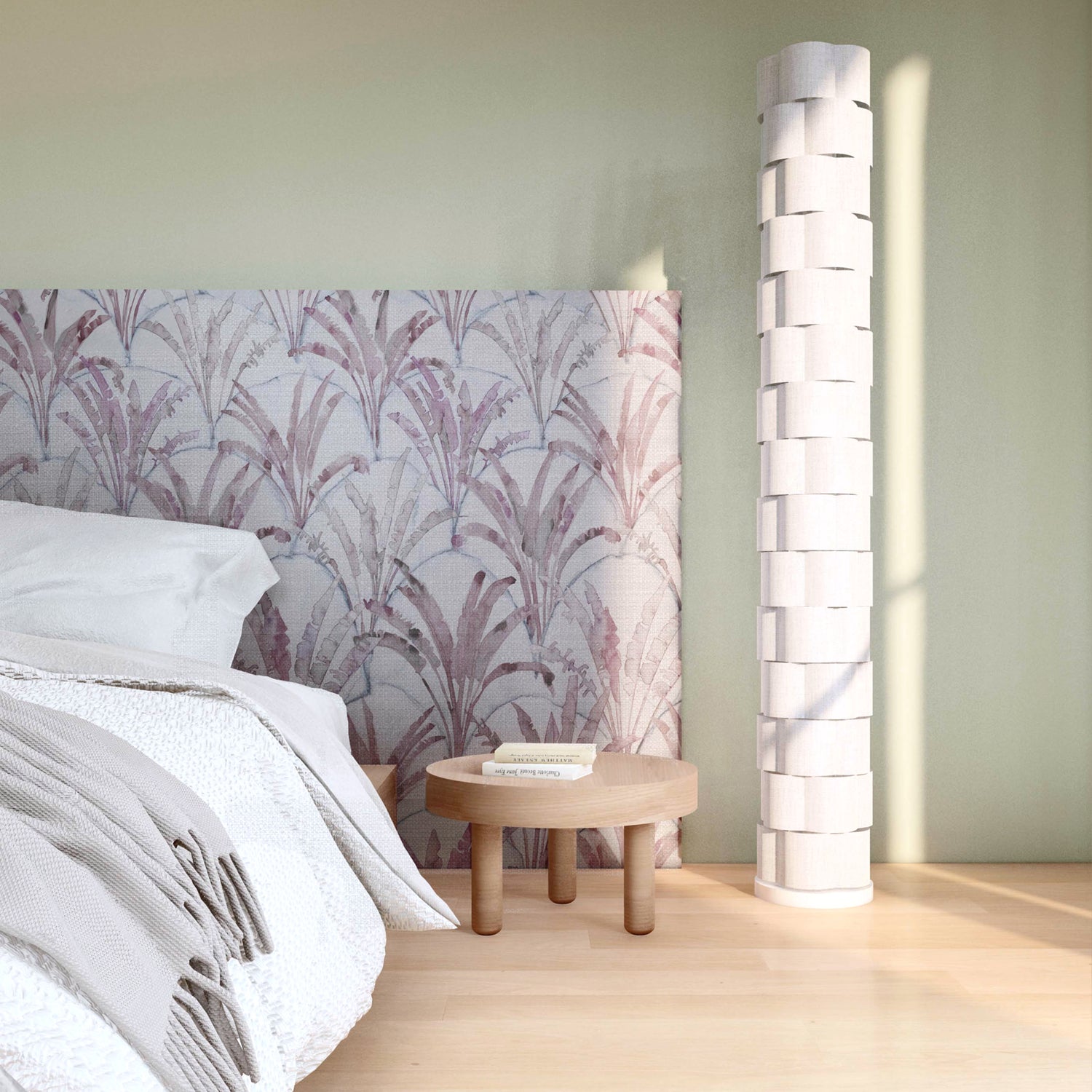 Bedroom vingette with upholstered headboard in a painterly palm tree pattern in shades of purple and navy on a gray field.