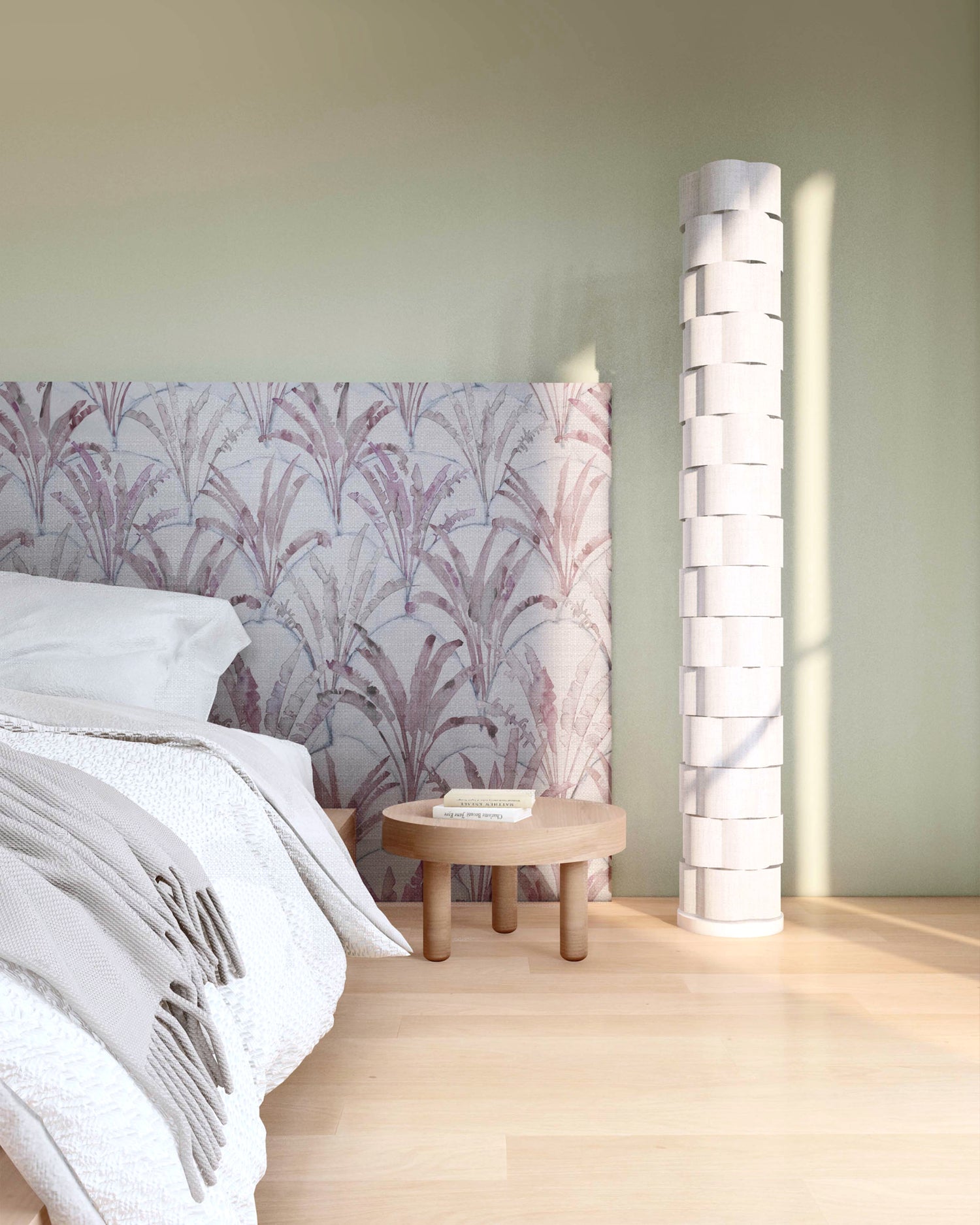 Bedroom vingette with upholstered headboard in a painterly palm tree pattern in shades of purple and navy on a gray field.