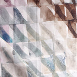 Detail of draped fabric in a painterly check pattern in shades of brown, blue and pink.
