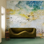 Living room with modernist couch and lamp against ethereal watercolor mural in blue, grey, yellow and grey. 