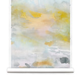 Wallpaper roll of an ethereal watercolor mural in shades of blue, green, yellow and grey. 