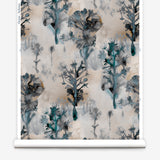 Wallpaper roll in a watercolor tree print in shades of turquoise, gray and gold on a cream field.