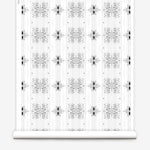 Wallpaper roll in a minimalist ikat pattern in shades of gray on a white field.