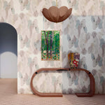 Interior with a sculputral console table against wallaper 'in watercolor elongated pill pattern in soft purple, tan and teal on a white field.