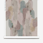 Wallpaper roll in watercolor elongated pill pattern in soft purple, tan and teal on a white field.