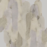 Detail of wallpaper in watercolor elongated pill pattern in tan, taupe and grey on a white field.
