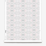 Wallpaper roll in a repeating ink blot print in shades of gray with turquoise and pink accents.