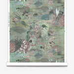Wallpaper roll in an underwater sealife scene in shades of sage green with coral accents. 