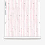 Wallpaper roll  in a painterly stripe print in light pink on a white field.