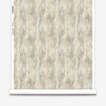 Wallpaper roll in a layered squiggle watercolor pattern in shades of grey and warn tan. 