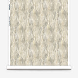Wallpaper roll in a layered squiggle watercolor pattern in shades of grey and warn tan. 