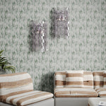 Vintage living room with striped couch and glass sconces against textural watercolor in muted teal. 