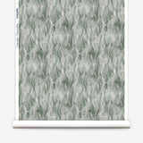 Wallpaper roll in a layered squiggle watercolor pattern in shades of muted teal. 